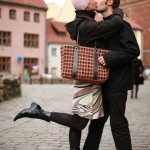 Young couple kissing in an old european town square. Young couple kissing in an old european town square.